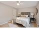 Bedroom with a ceiling fan, a gray upholstered headboard and matching side tables with lamps at 937 Clarkson St # 101, Denver, CO 80218