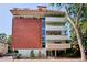 Brick and white exterior shows balconies on the building at 937 Clarkson St # 101, Denver, CO 80218