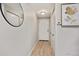 Bright hallway featuring wood floors, modern lighting and decorative mirror and artwork at 937 Clarkson St # 101, Denver, CO 80218