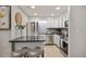 Well-lit kitchen with white cabinets, stainless steel appliances, and black countertop island with seating at 937 Clarkson St # 101, Denver, CO 80218