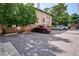 Rear parking lot with ample spaces and shade trees at 937 Clarkson St # 101, Denver, CO 80218