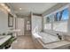 Elegant bathroom with a soaking tub, large window, stand-alone sink, and separate shower behind a partition at 1716 S Ogden St, Denver, CO 80210