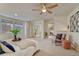 Bright bedroom with a ceiling fan, neutral carpet, large windows, and a walk in closet with mirrored doors at 1716 S Ogden St, Denver, CO 80210