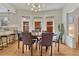 Bright dining room features a round table, modern chandelier, and three large windows at 1716 S Ogden St, Denver, CO 80210