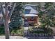 Charming brick home with a well-maintained front yard, mature trees, and a welcoming front porch at 1716 S Ogden St, Denver, CO 80210