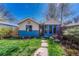 Charming exterior of a home with mature landscaping and a stone path leading to the front door at 1716 S Ogden St, Denver, CO 80210