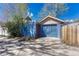 Exterior view of a detached garage with blue siding and a matching garage door and red entry door at 1716 S Ogden St, Denver, CO 80210