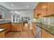 Open kitchen with granite countertops, stainless steel appliances, and wood cabinets at 1716 S Ogden St, Denver, CO 80210