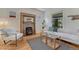 Comfortable living room features a charming fireplace, hardwood floors, and modern decor at 1716 S Ogden St, Denver, CO 80210