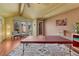 Bright living room with hardwood floors and exposed wood beams, furnished with massage table at 1716 S Ogden St, Denver, CO 80210