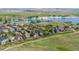 Panoramic aerial view of a residential neighborhood with a lake and lush greenery at 26741 E Arbor Dr, Aurora, CO 80016