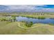 Expansive aerial view of the neighborhood, showcasing the lake and walking paths at 26741 E Arbor Dr, Aurora, CO 80016