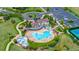 Aerial view of the community clubhouse, swimming pool, playground, tennis court, and parking at 26741 E Arbor Dr, Aurora, CO 80016