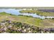 Expansive aerial view showcasing houses near a body of water with picturesque trails and open fields at 26741 E Arbor Dr, Aurora, CO 80016