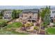 Spacious backyard featuring a deck, patio, lush landscaping, and an iron fence at 26741 E Arbor Dr, Aurora, CO 80016