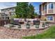 Cozy backyard patio with an outdoor seating area and a stone fire pit for entertaining at 26741 E Arbor Dr, Aurora, CO 80016