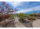 Scenic backyard with a stone pathway, mature trees, and lush landscaping at 26741 E Arbor Dr, Aurora, CO 80016