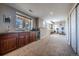 Finished basement area featuring a wet bar, dark wood cabinets, carpeted floors, and recessed lights at 26741 E Arbor Dr, Aurora, CO 80016