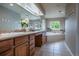 Large bathroom with double sinks, granite counters, large soaking tub and tiled floors at 26741 E Arbor Dr, Aurora, CO 80016