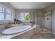 Relaxing bathroom with soaking tub, shower and serene window view at 26741 E Arbor Dr, Aurora, CO 80016