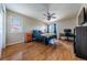 This bedroom features hardwood floors, a ceiling fan, furnishings, and a large bed with blue comforter at 26741 E Arbor Dr, Aurora, CO 80016