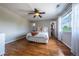 Comfortable bedroom featuring a ceiling fan, hardwood floors, and natural light from a window at 26741 E Arbor Dr, Aurora, CO 80016