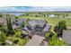 Beautiful two-story home featuring a three-car garage, basketball hoop, and lovely front yard landscaping at 26741 E Arbor Dr, Aurora, CO 80016