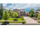Charming two-story home featuring a well-manicured lawn, mature trees, and a long driveway at 26741 E Arbor Dr, Aurora, CO 80016