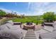 Inviting backyard featuring an outdoor seating area with a stone fire pit and lovely landscaping at 26741 E Arbor Dr, Aurora, CO 80016