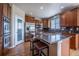 Updated kitchen with granite counters, stainless appliances, central island with gas cooktop and breakfast bar at 26741 E Arbor Dr, Aurora, CO 80016