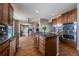 Modern kitchen with stainless steel appliances, granite countertops, and hardwood floors at 26741 E Arbor Dr, Aurora, CO 80016