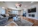 Comfortable living room with a fireplace, large windows, and stylish decor at 26741 E Arbor Dr, Aurora, CO 80016