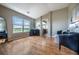 Bright living room featuring hardwood floors, a large window overlooking scenic views, and comfortable seating at 26741 E Arbor Dr, Aurora, CO 80016
