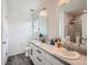 Bright and spacious bathroom with double sinks, modern fixtures, and a glass-enclosed shower at 17991 E 103Rd Ave, Commerce City, CO 80022