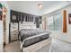 Comfortable bedroom with a large bed, modern decor, and natural light at 17991 E 103Rd Ave, Commerce City, CO 80022