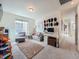 Bonus room with neutral colored walls, carpet, desk, chair and pull out couch at 17991 E 103Rd Ave, Commerce City, CO 80022