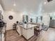 Open-concept kitchen with granite countertops, white cabinets, and view of the living room at 17991 E 103Rd Ave, Commerce City, CO 80022