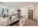 Modern kitchen island with stainless steel appliances and seamless access to the living space at 17991 E 103Rd Ave, Commerce City, CO 80022