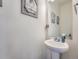 Charming powder room with a pedestal sink and decorative wall art at 17991 E 103Rd Ave, Commerce City, CO 80022