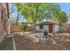Charming backyard with mature tree, patio, pergola, and detached garage at 1601 Albion St, Denver, CO 80220
