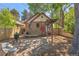 Rear yard with BBQ grill, stone accents, detached garage and wood pergola at 1601 Albion St, Denver, CO 80220