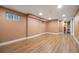Spacious basement featuring wood-look floors, neutral paint, and recessed lighting at 1601 Albion St, Denver, CO 80220