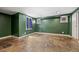 Finished basement with tile floor and painted in dark green at 1601 Albion St, Denver, CO 80220