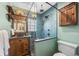 Luxurious bathroom boasts a tile shower, unique lighting and wood accents at 1601 Albion St, Denver, CO 80220