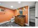Bathroom features wood vanity with black countertop, ornate mirror, and tile flooring at 1601 Albion St, Denver, CO 80220