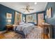 Bright bedroom with hardwood floors, ceiling fan, and large windows at 1601 Albion St, Denver, CO 80220