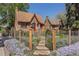Beautiful front exterior with a manicured lawn, stone pathway, and wrought iron fence at 1601 Albion St, Denver, CO 80220