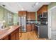 Updated kitchen with stainless appliances, granite countertops, subway tile, and breakfast bar at 1601 Albion St, Denver, CO 80220