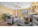 Cozy living room featuring a fireplace, ceiling fan and hardwood floors at 1601 Albion St, Denver, CO 80220