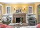 Close up of the cozy living room featuring a brick fireplace, built-in shelves, and comfortable seating at 1601 Albion St, Denver, CO 80220